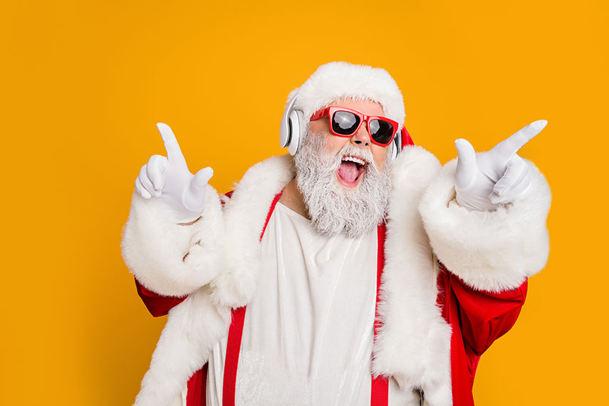Excited Santa with headphones and sunglasses promoting holiday advertising